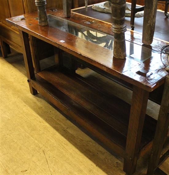A rustic side table with glass panels